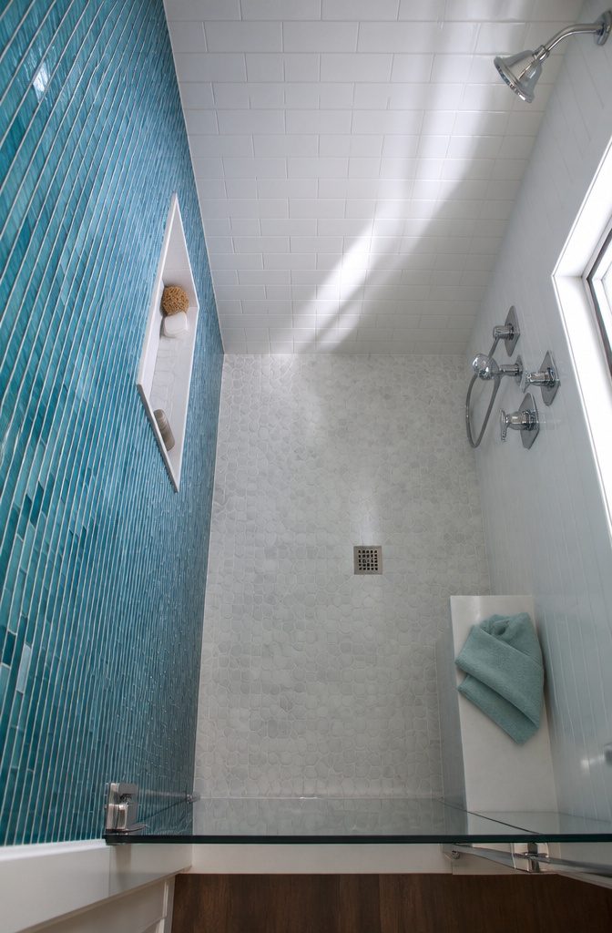 Polished hexagon mosaic tiles forming a shower accent wall