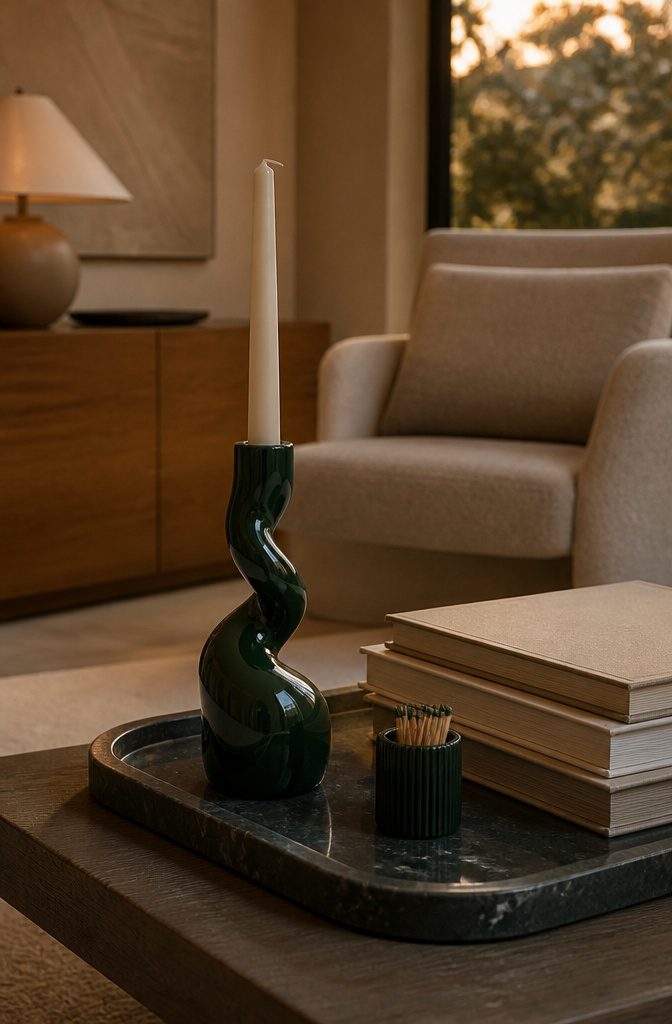 Sculptural candlestick on a tray next to stacked books