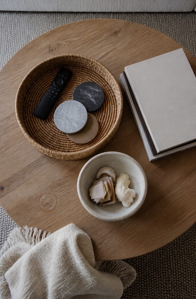 Shallow bowl beside stacked books on a coffee table