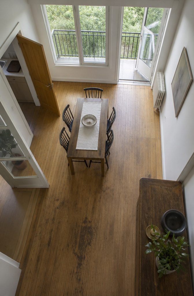 Dining room with table near windows a balcony door and room openings