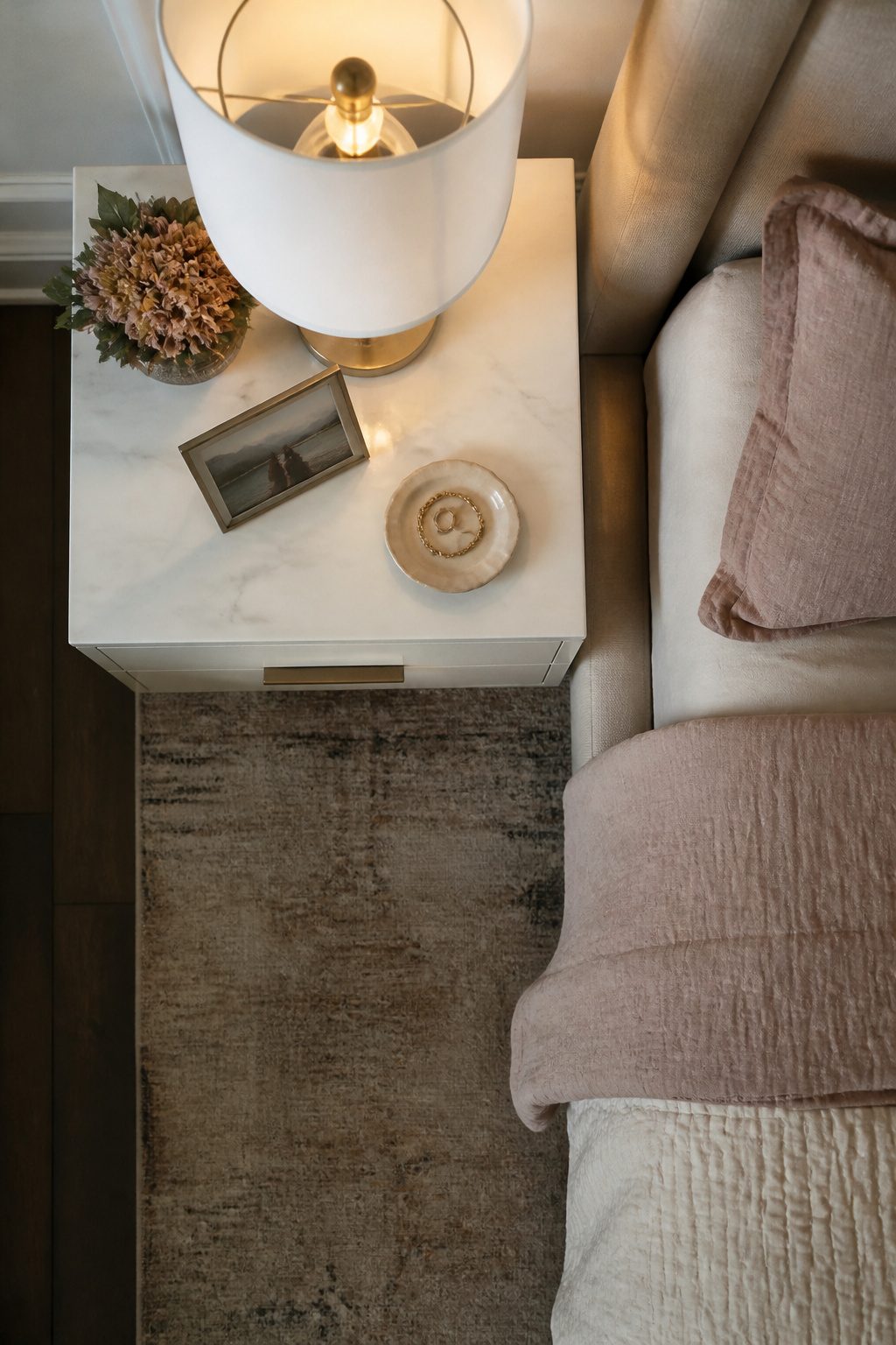 A clear nightstand with minimal decor enhances the room's serenity.