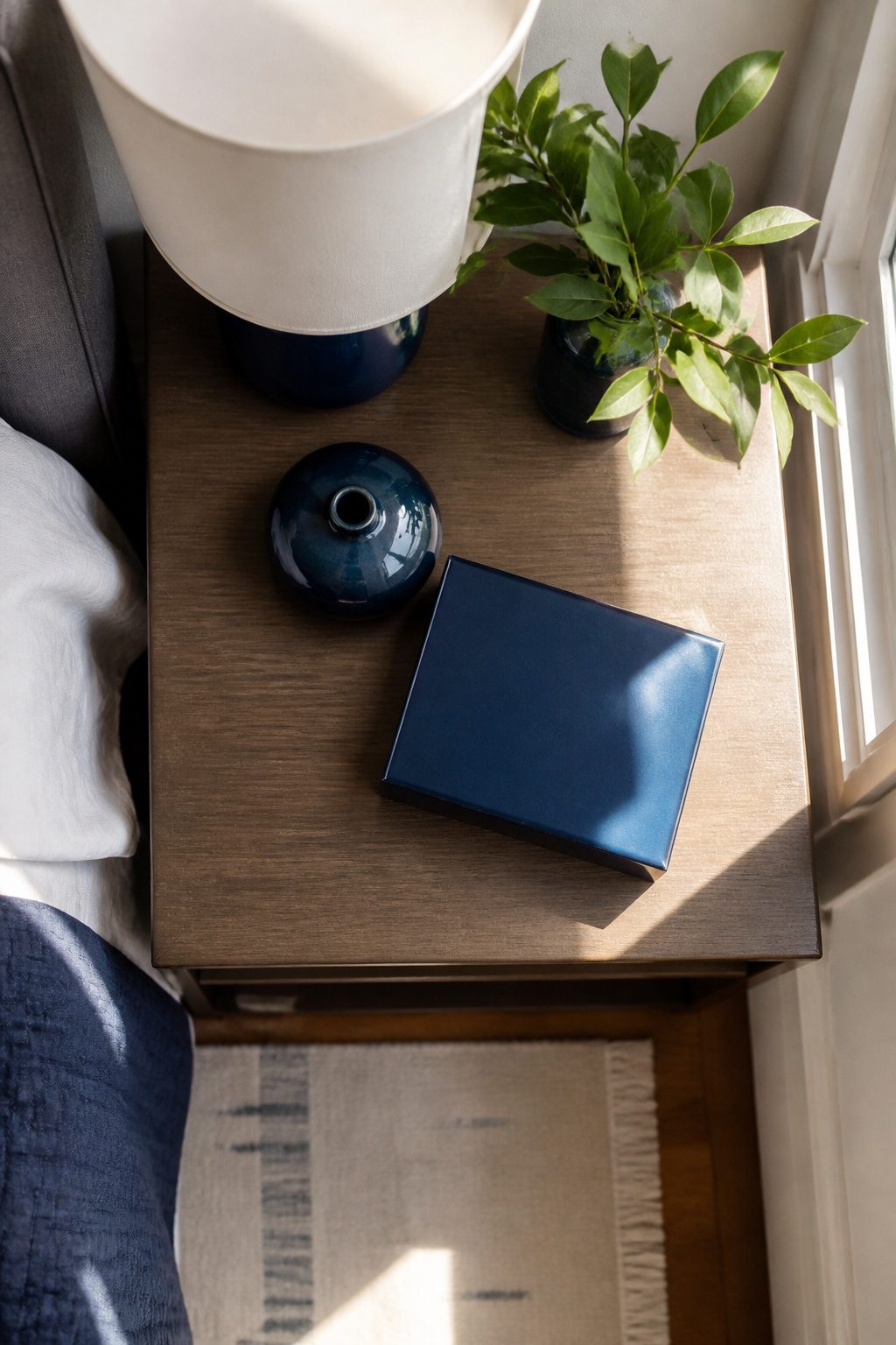 Cluster of navy decorative items on a nightstand.